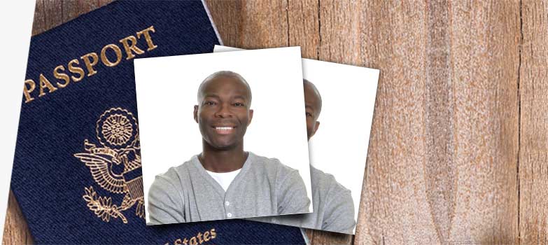 Passport cover and passport photo on desk.